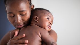 Close up of Black mother holding baby