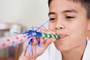 Boy Blowing Party Horn