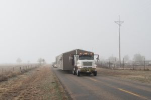 Truck transporting a house