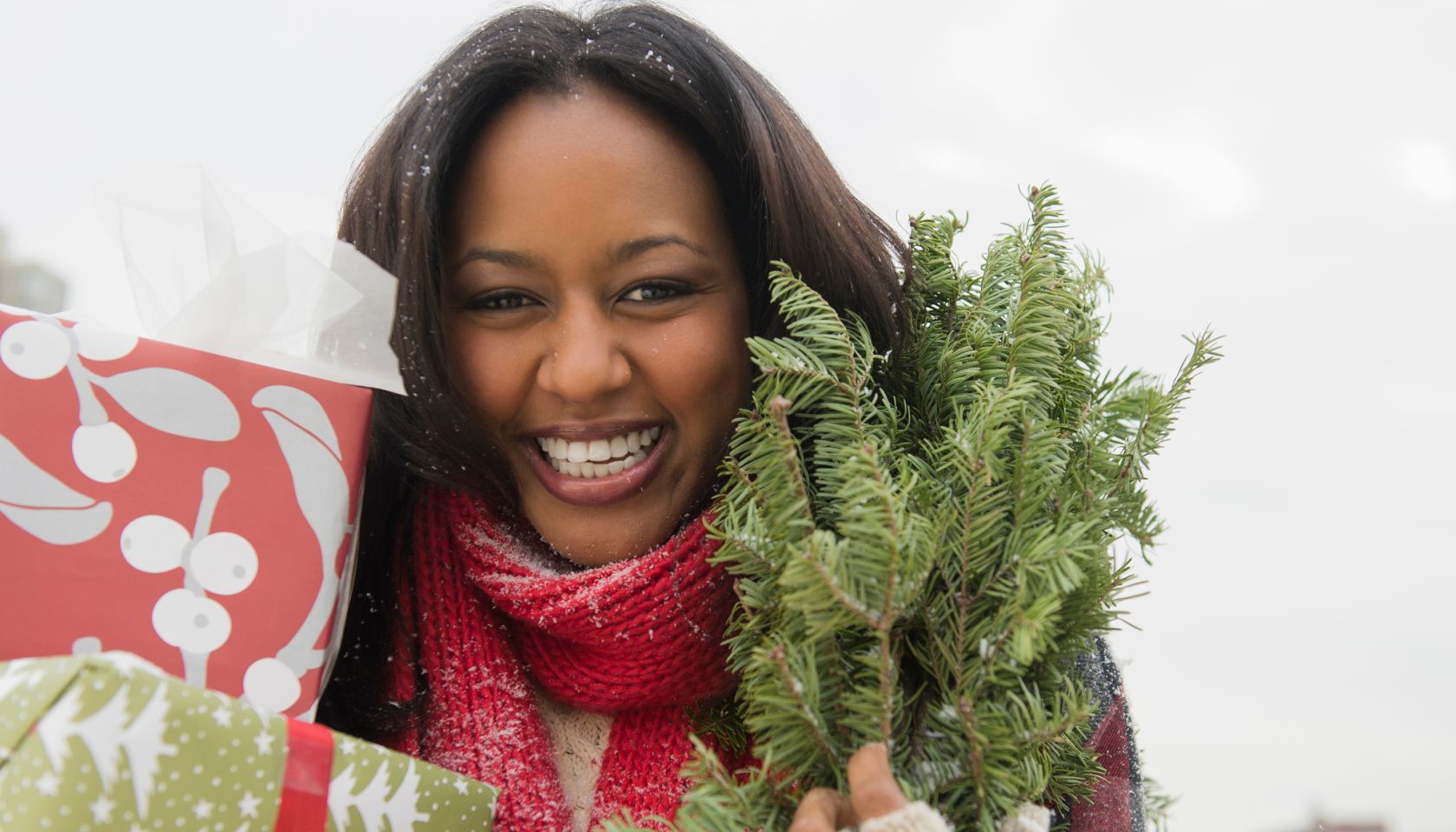 African American woman carrying Christmas presents