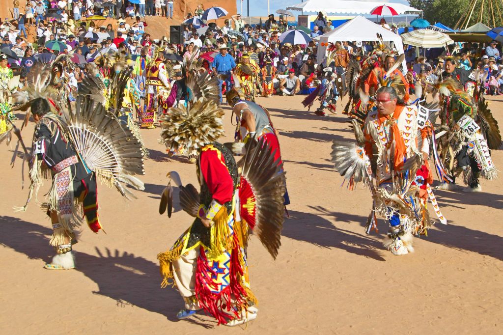 Native Americans in full regalia dancing at Pow wow