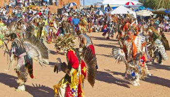 Native Americans in full regalia dancing at Pow wow