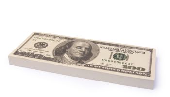 Close-Up Of Us Paper Currency Bundle Over White Background