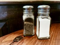 Salt and Pepper Shaker on Table in Restaurant