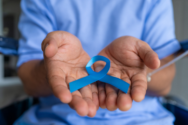 Close up asian man prostate cancer patient holding a blue ribbon as a symbol of prostate cancer awareness, Prostate cancer awareness concept.